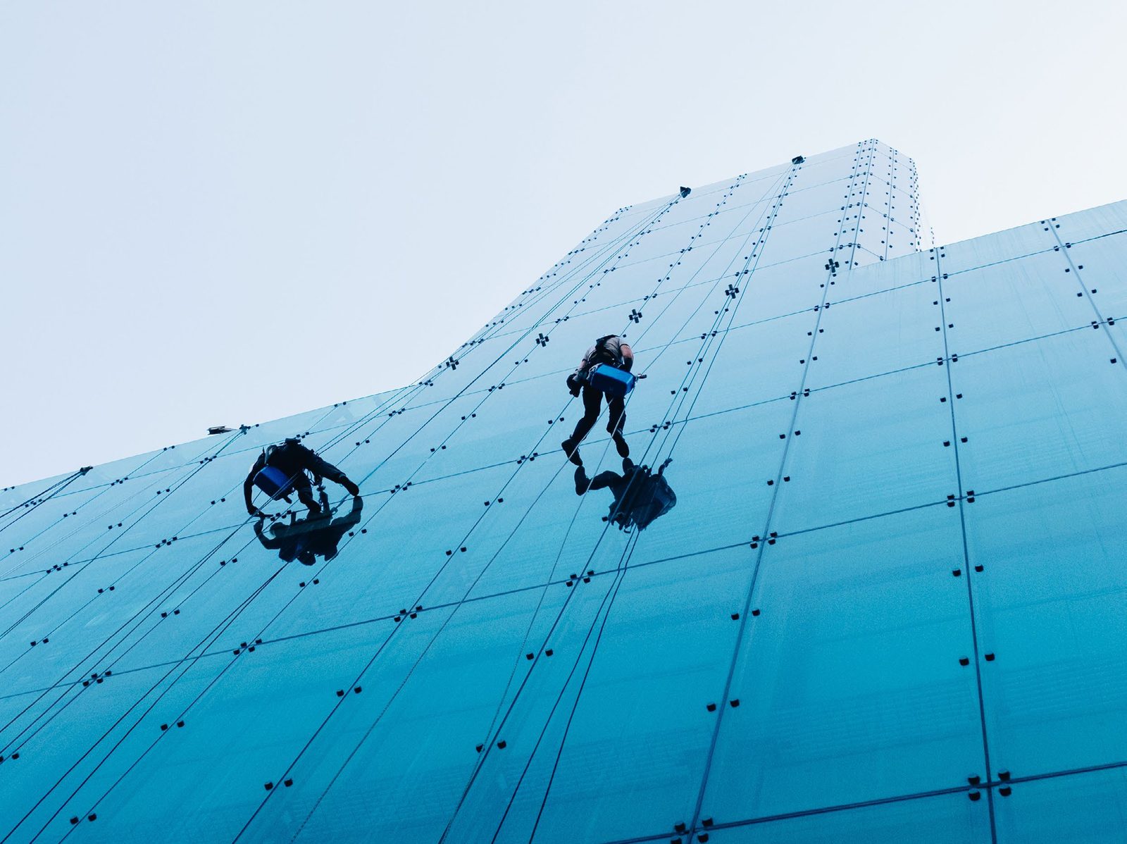 Rope-access technicians on a high-rise glass facade